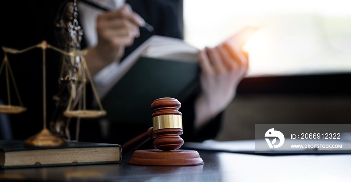 Wooden gavel on desk with lawyer working on background, copy space, banner and background.