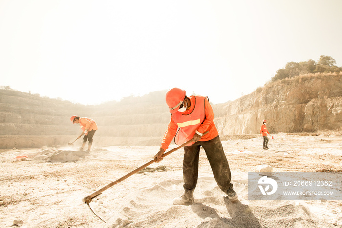 Miners working in dusty and baking hot.