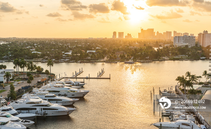 Luxury yacht parked on a canal with the sun coming down at Fort Lauderdale. Port of Fort Lauderdale with Sunset at the marina area