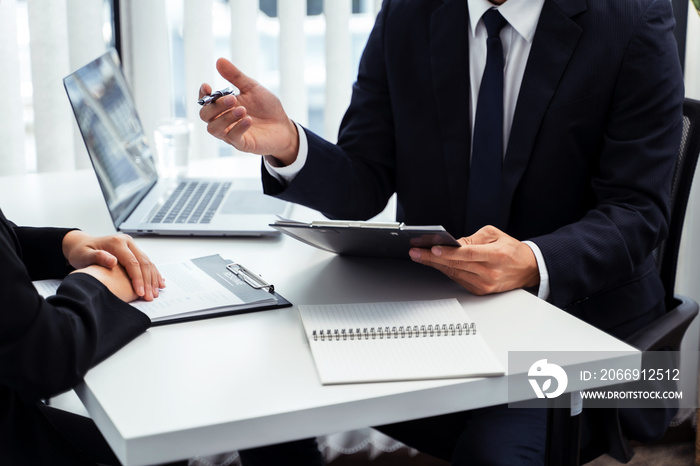 Examiner reading a resume during job interview at office