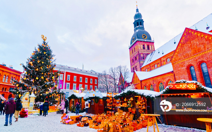 Cityscape with Christmas Market at Dome Cathedral square in Winter Riga, Latvia. Advent Fair Decoration and Stalls with Crafts Items on the Bazaar. Latvian street Xmas and holiday