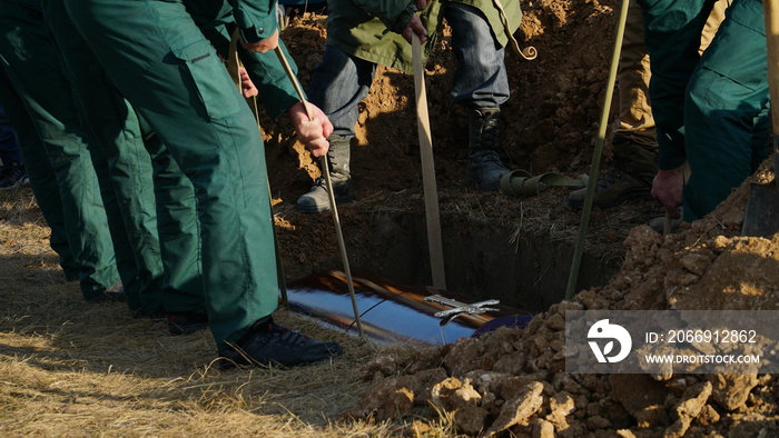 Funeral ceremony. People come to say goodbye. Burial in the grave.