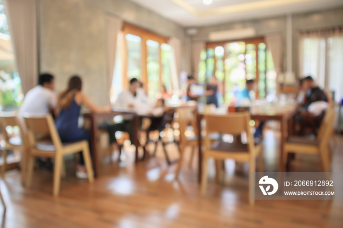 Restaurant interior with customer and wood table blur abstract background with bokeh light