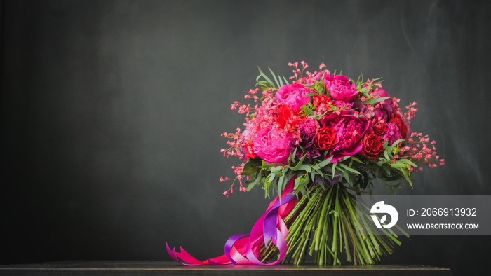 Beautiful wedding bouquet on the black background. Floristry and handmade concept