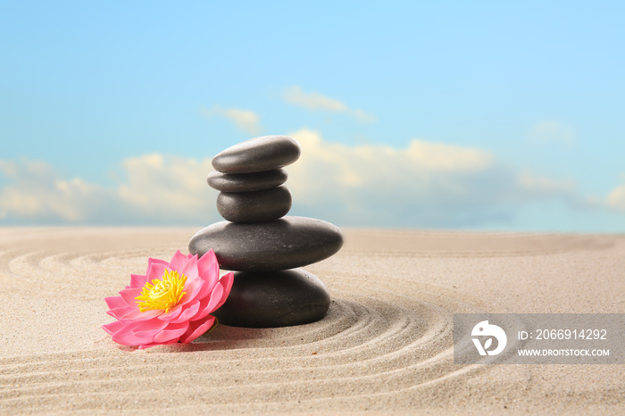 Stones and flower on sand outdoors. Zen concept