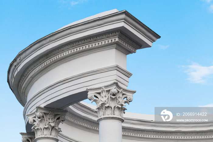 Portico fragment, white columns under sky