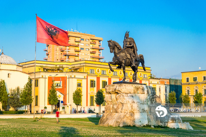 Skanderbeg square with flag, Skanderbeg monument and The Et’hem Bey Mosque in the center of Tirana city, Albania.