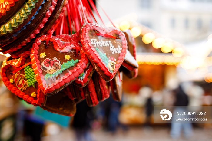 Gingerbread Hearts at German Christmas Market. Nuremberg, Munich, Berlin, Hamburg xmas market in Germany. On traditional ginger bread cookies written Merry Chrismtas called Lebkuchen in German