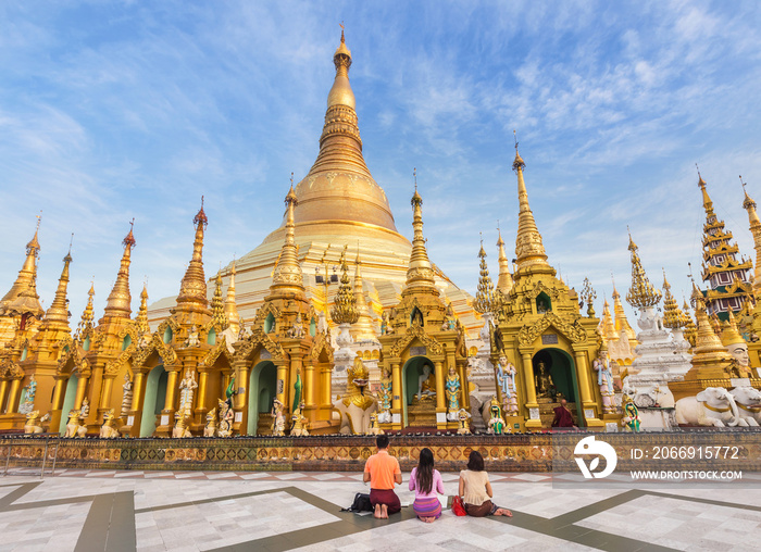 family burmese people  praying respects at Shwedagon big golden pagoda most sacred Buddhist pagoda in rangoon, Myanmar(Burma)