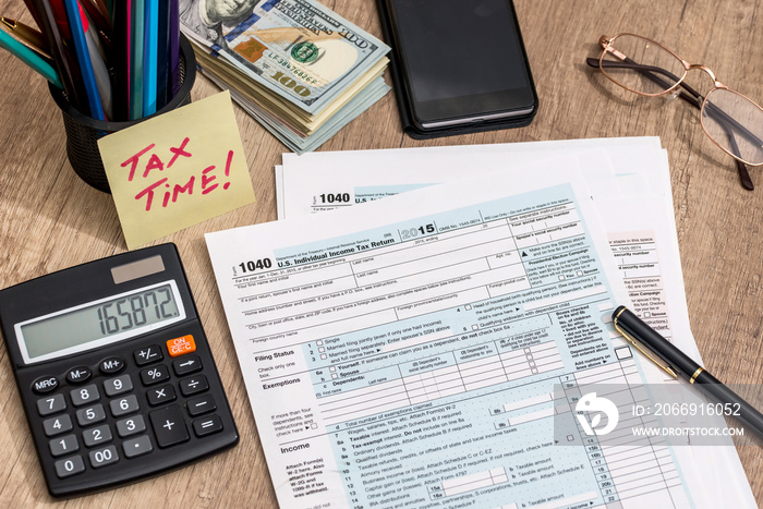 tax form with calculator, money and pen