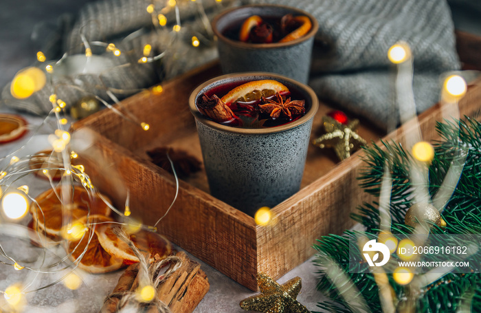 Christmas mulled wine. Winter cozy composition with two cup on wooden tray