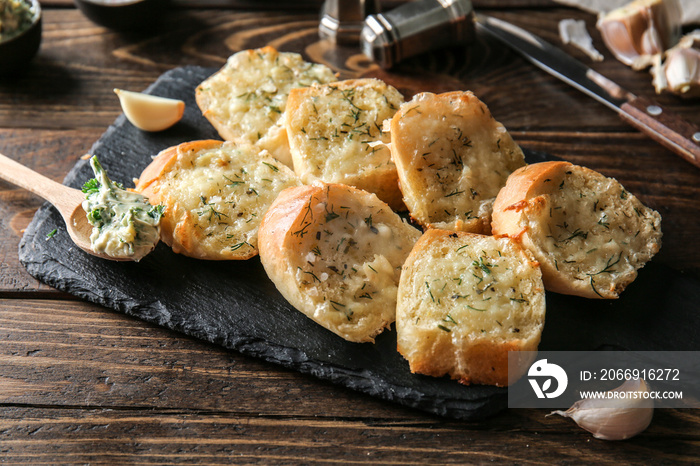 Tasty garlic bread on table