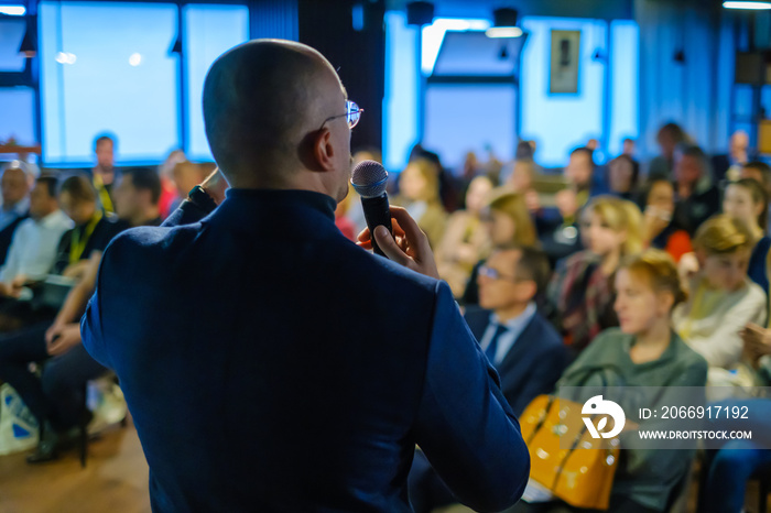 Male presenter speaks to audiences