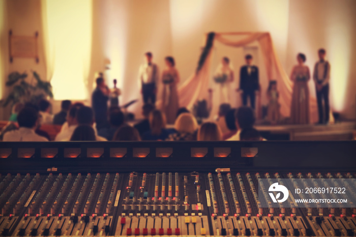 Professional audio mixing console playing music on wedding ceremony