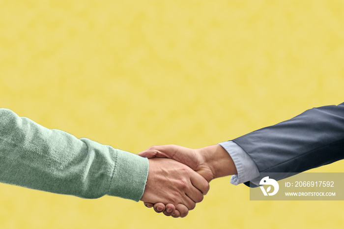 handshake on yellow background verbal agreement concept