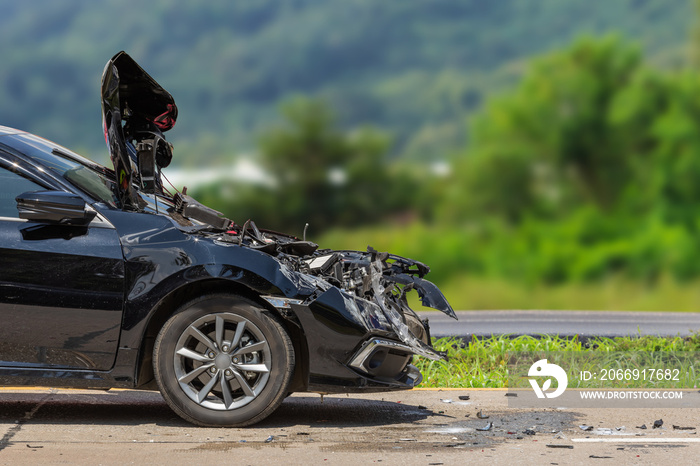 Front of black modern car got damaged by accident on the road