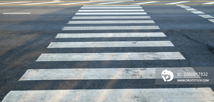 crosswalk on the road for safety when people walking cross the street, Pedestrian crossing on a repaired asphalt road, Crosswalk on the street for safety.