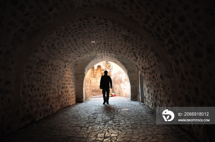 silhouette of a person in a tunnel