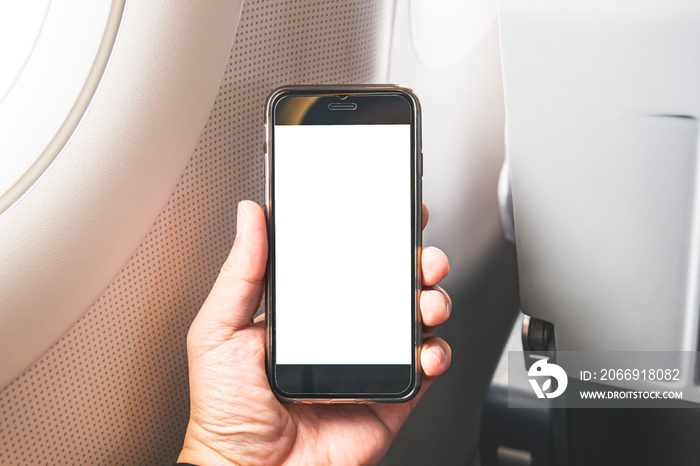 mobile phone smart device mock up, male hand holding phone with white blank canvas screen, in airplane sitting window view, interaction touching white space for logo website app user interface