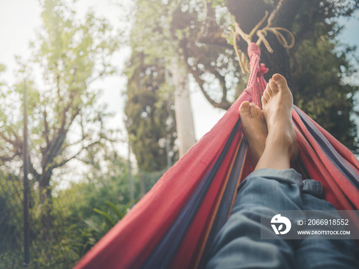 nude feet relaxing on hammock in spring season