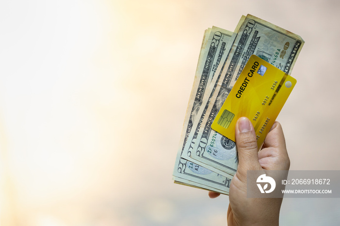 Money and Business concept. Close up of woman hand holding credit card and 20 US dollars banknote with copy space.