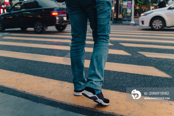 fashionable man crossing the street