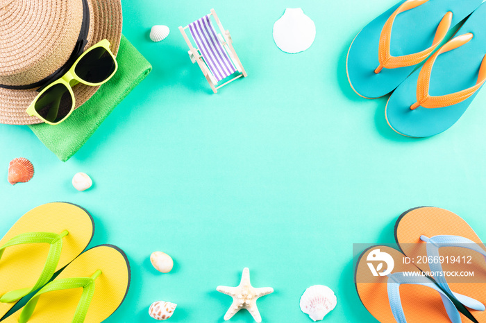 Beach, sunglasses, flip flops starfish beach hat and sea shell on green pastel background for summer holiday and vacation concept.