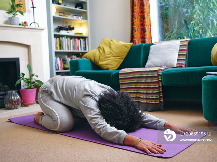 Woman practicing yoga at home