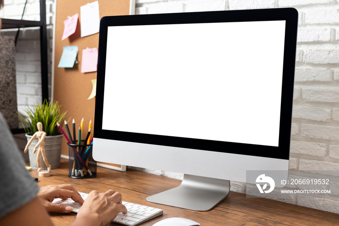 woman working empty screen computer on wood desk in home office.