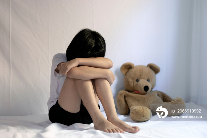 Sad little girl sitting in room. human trafficking concept.