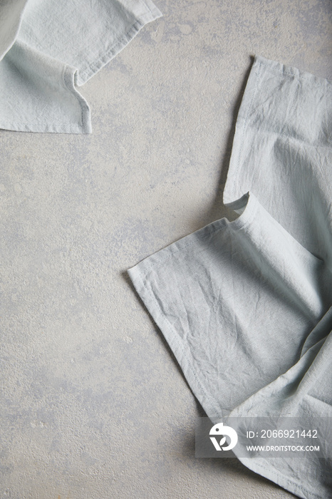 Light linen napkin on gray concrete texture or background. With place for text and image