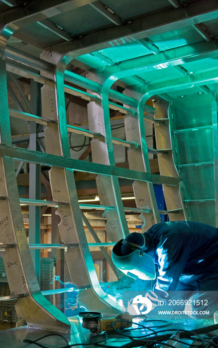 Welding. Aluminium hull of a super sailing yacht at the shipyard. Boat casco. Shipbuiling industry.