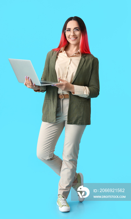 Female programmer with laptop on color background