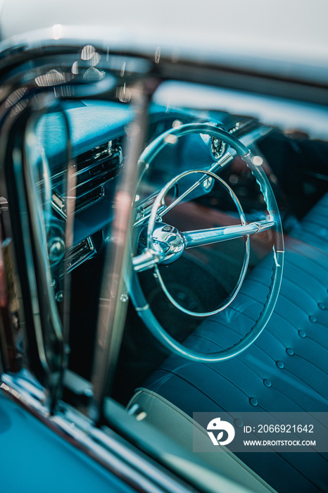 Oldtimer car dashboard. Retro car interior. Old steering wheel detail.