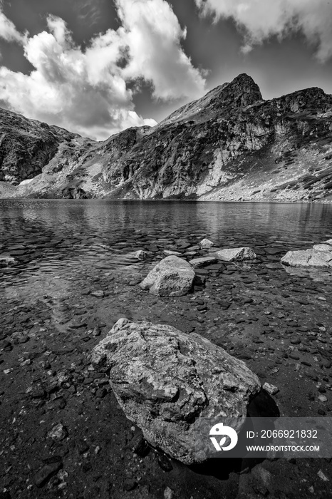 beauty black and white  landscape on the mountain lake with a big rock at the front