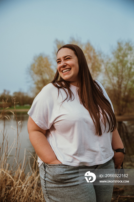 portrait of a plus size woman smiling and looking away