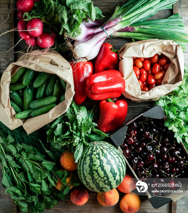 fresh and ripe fruits and vegetables in eco paper packing, cherry, pepper, watermelon,  cerry tomatoes, herbs