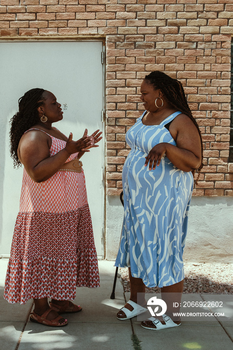 2 plus size African American women talk together