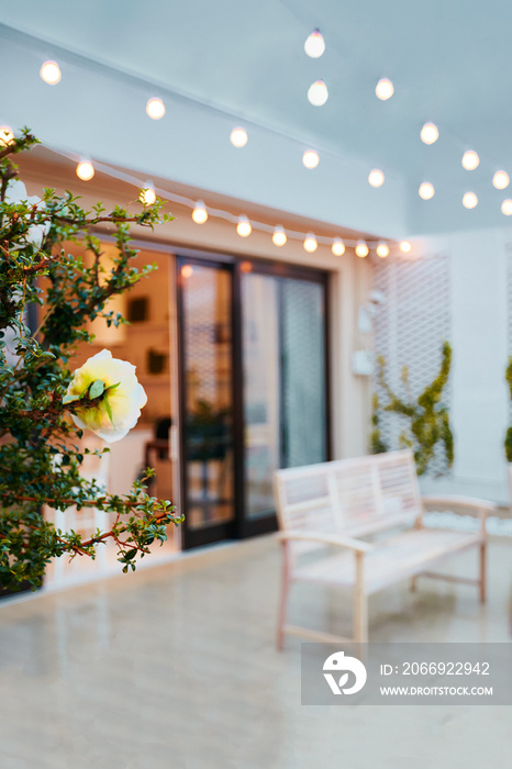 cozy rooftop patio with outdoor lights at rainy evening