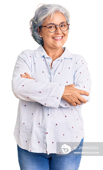 Senior woman with gray hair wearing casual business clothes and glasses happy face smiling with crossed arms looking at the camera. positive person.