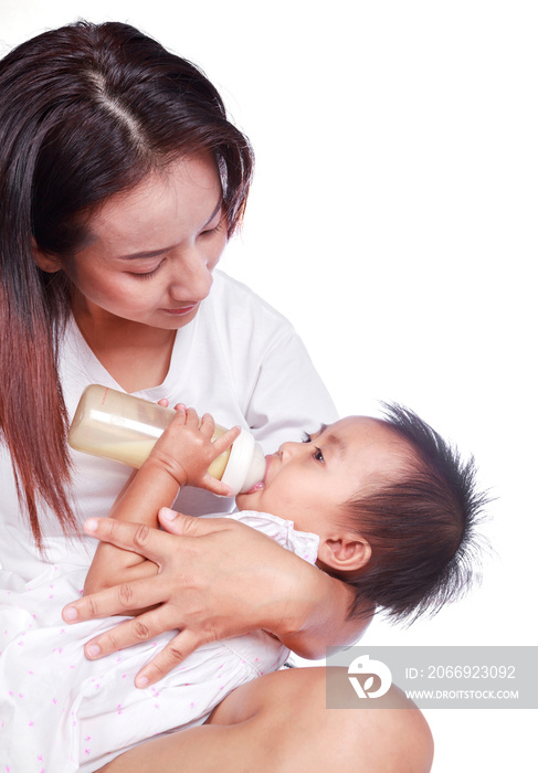 Mother feeding baby daughter isolated on white background