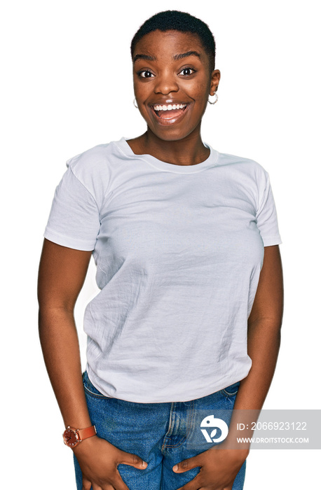 Young african american woman wearing casual white t shirt winking looking at the camera with sexy expression, cheerful and happy face.