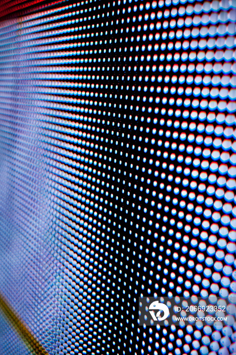 LED screen. dotted bright colored LED smd screen - close up background. Abstract Led wall with graduated focus