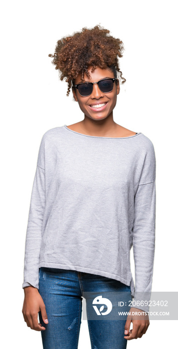 Beautiful young african american woman wearing sunglasses over isolated background with a happy and cool smile on face. Lucky person.