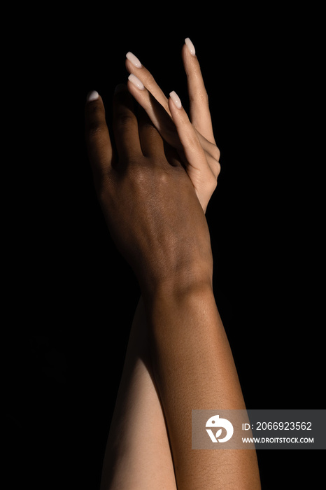 Plexus of female hands. Graceful female hands touch each other isolated on dark studio background. Concept of diversity, unity, love, support