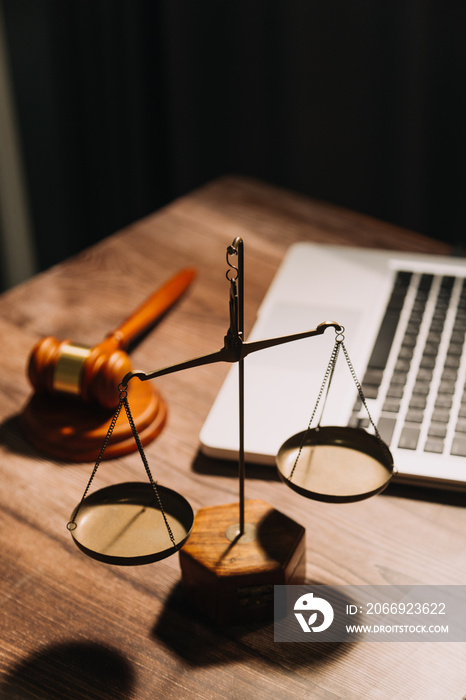 Business and lawyers discussing contract papers with brass scale on desk in office. Law, legal services, advice, justice and law concept picture with film grain effect