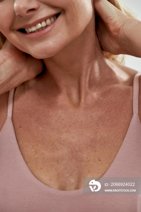 Neckline of smiling middle aged caucasian woman