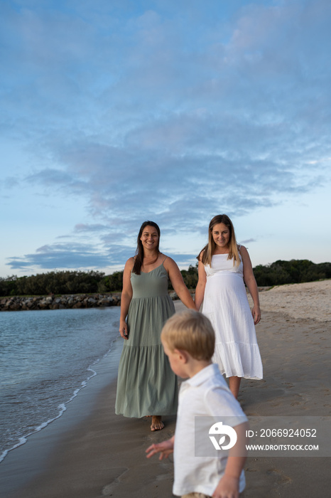 lesbian couple following son on beach