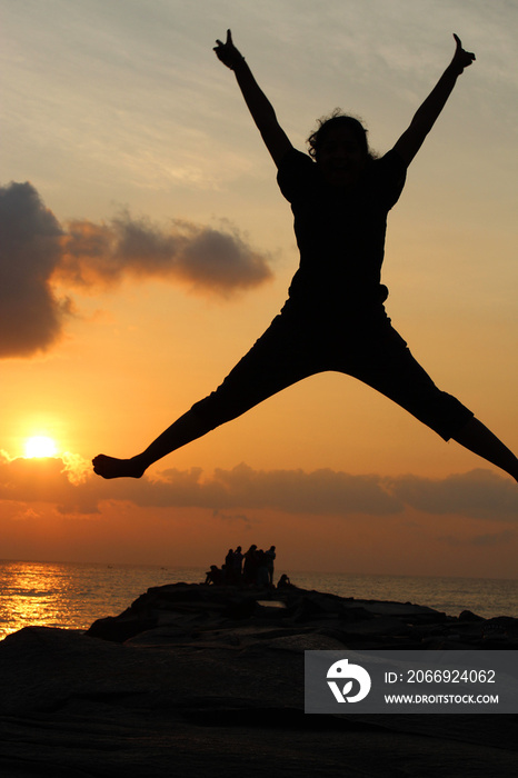 Silhouette of a girl jumping, serenity beach, Pondicherry, Tamil Nadu, India