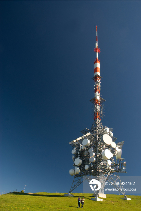 89 meters high, Antenna tower on the top of Niederhorn,  it broadcasts FM radio and television since 1975, close to Beatenberg and Interlaken, canton Bern, Switzerland, Europe, two girls walking